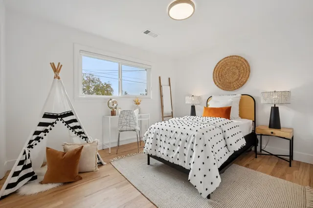 a bedroom with a large bed and a chandelier
