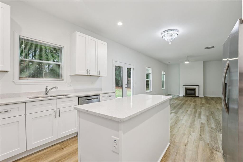 4405 Belcamp Road Fairburn, GA 30213 - Photo 13 of 60 a large kitchen with kitchen island a sink stainless steel appliances and cabinets