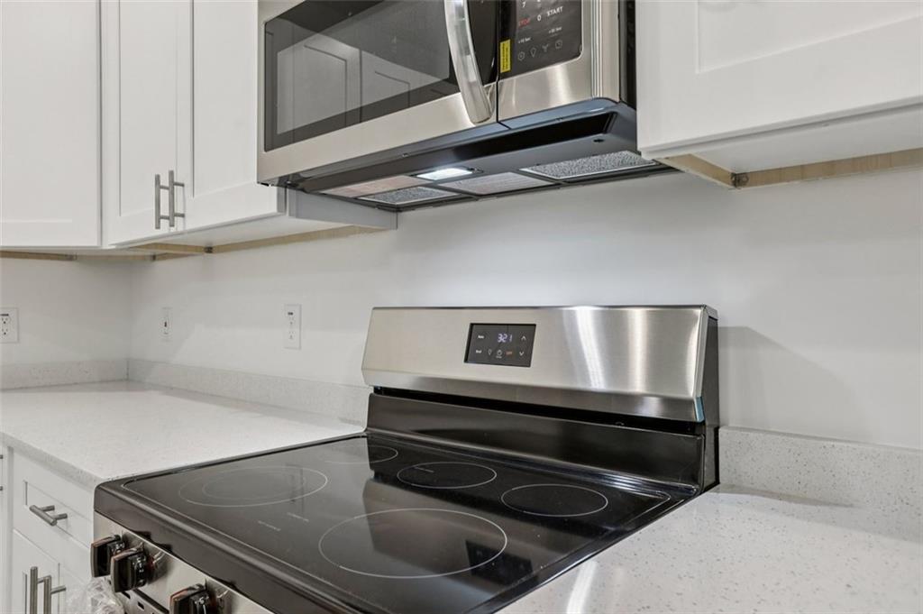 4405 Belcamp Road Fairburn, GA 30213 - Photo 16 of 60 a stove top oven sitting inside of a kitchen