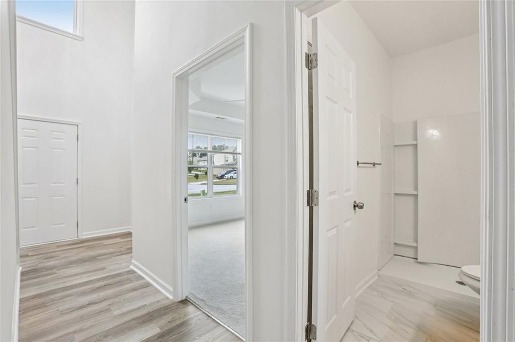 4405 Belcamp Road Fairburn, GA 30213 - Photo 18 of 60 a view of a hallway with wooden floor and closet