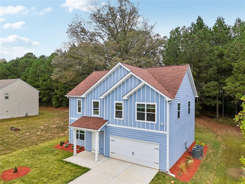 4405 Belcamp Road Fairburn, GA 30213 - Photo 2 of 60 a front view of a house with garden