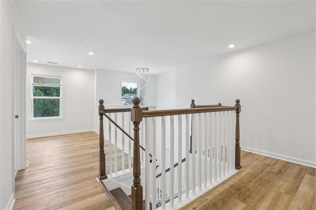 4405 Belcamp Road Fairburn, GA 30213 - Photo 22 of 60 a view of a hallway with wooden floor and stairs