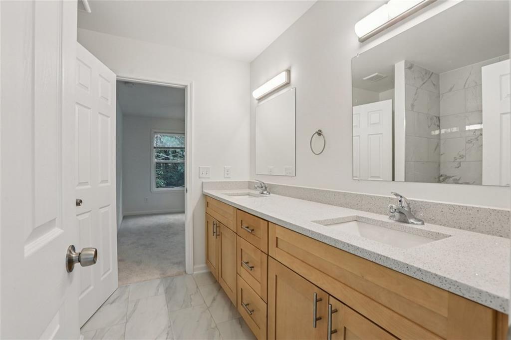 4405 Belcamp Road Fairburn, GA 30213 - Photo 27 of 60 a spacious bathroom with a double vanity sink mirror and