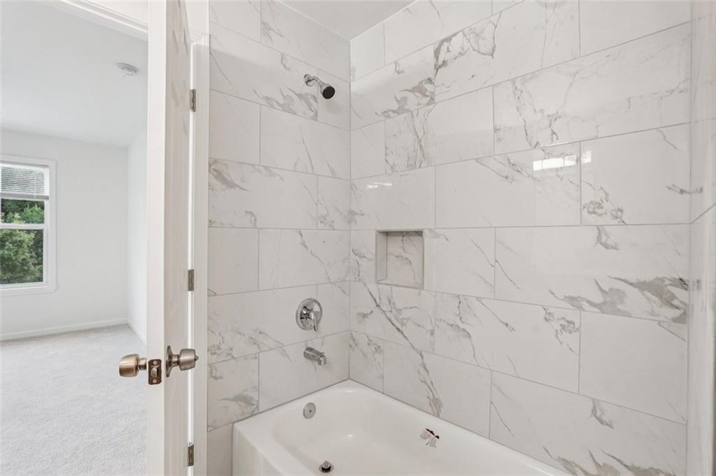 4405 Belcamp Road Fairburn, GA 30213 - Photo 28 of 60 a bathroom with a bathtub