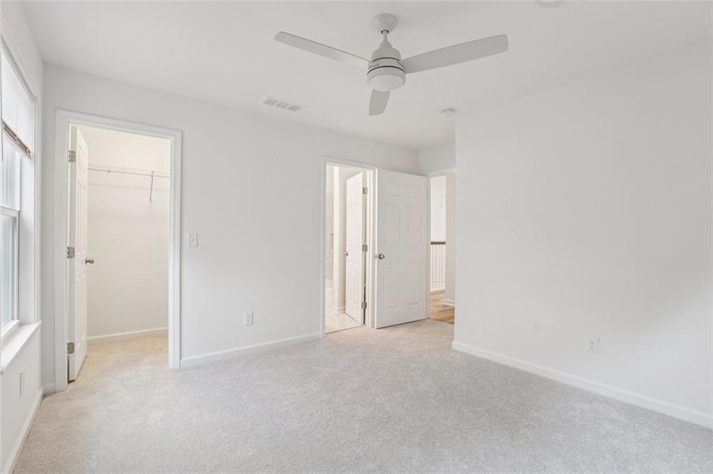 4405 Belcamp Road Fairburn, GA 30213 - Photo 30 of 60 an empty room with a ceiling fan and a window