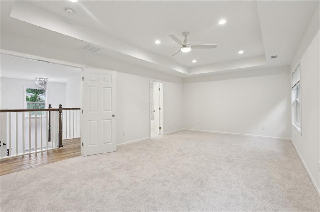 4405 Belcamp Road Fairburn, GA 30213 - Photo 35 of 60 an empty room with staircase and white walls