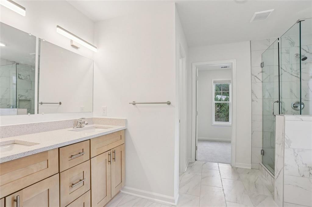 4405 Belcamp Road Fairburn, GA 30213 - Photo 40 of 60 a bathroom with a granite countertop sink mirror and shower