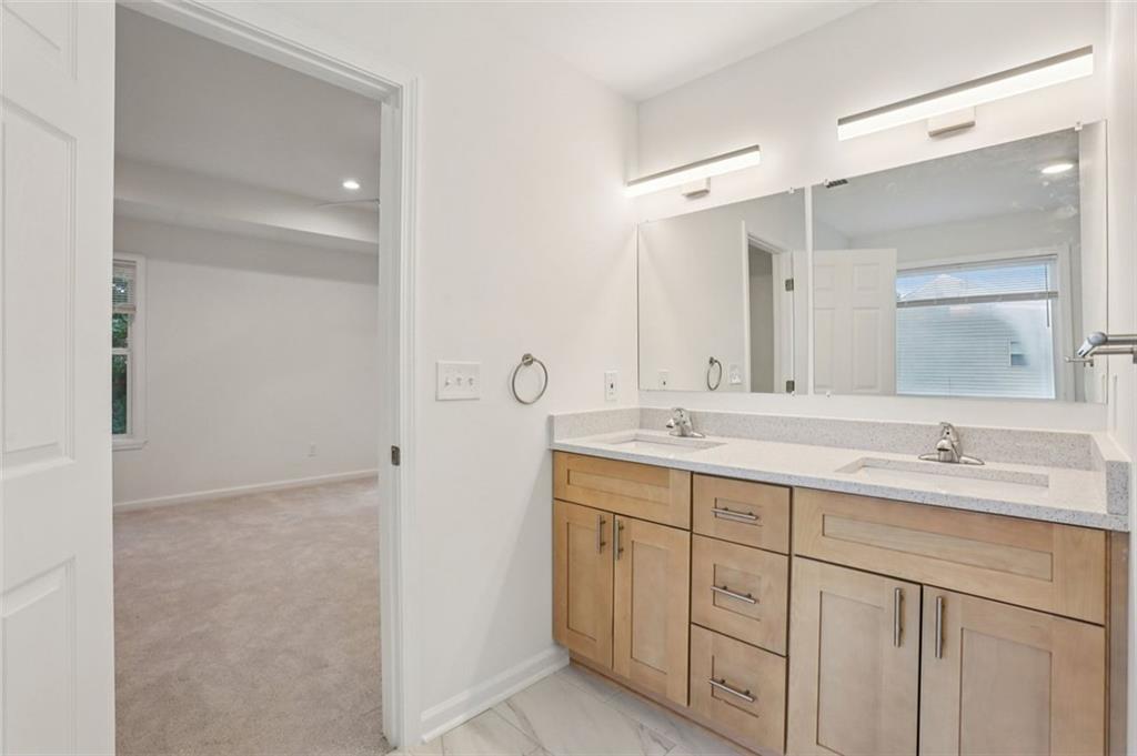 4405 Belcamp Road Fairburn, GA 30213 - Photo 41 of 60 a bathroom with a double vanity sink mirror and