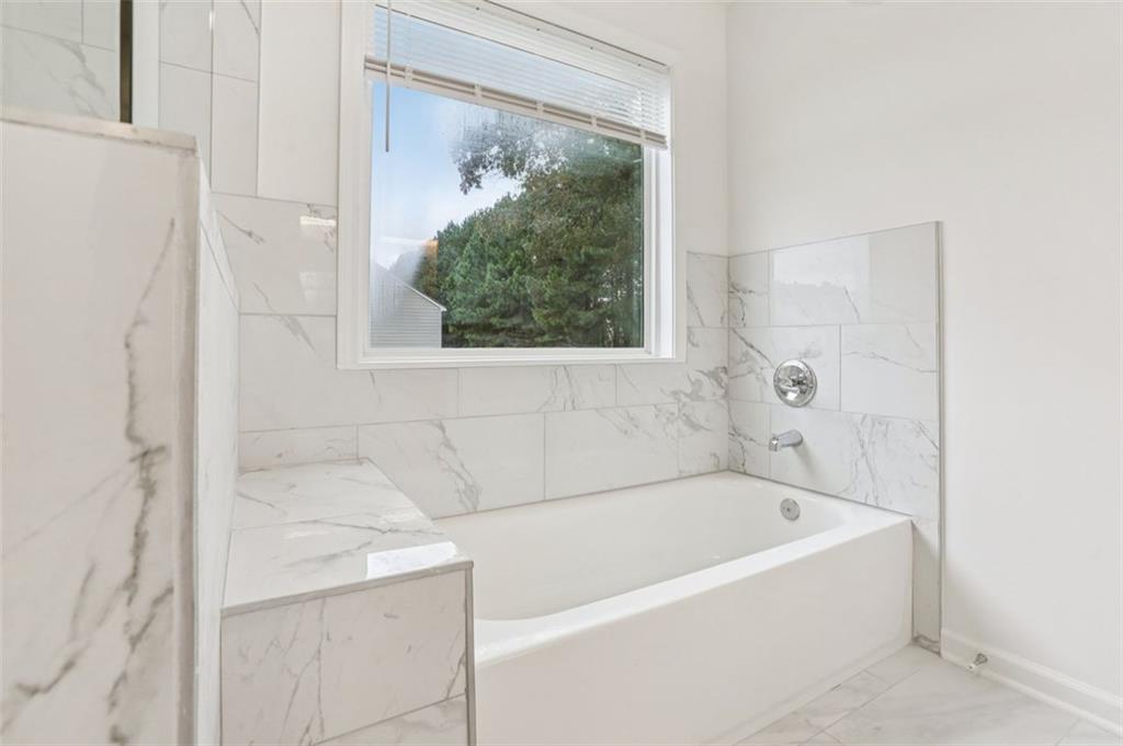 4405 Belcamp Road Fairburn, GA 30213 - Photo 42 of 60 a white bath tub sitting next to a window