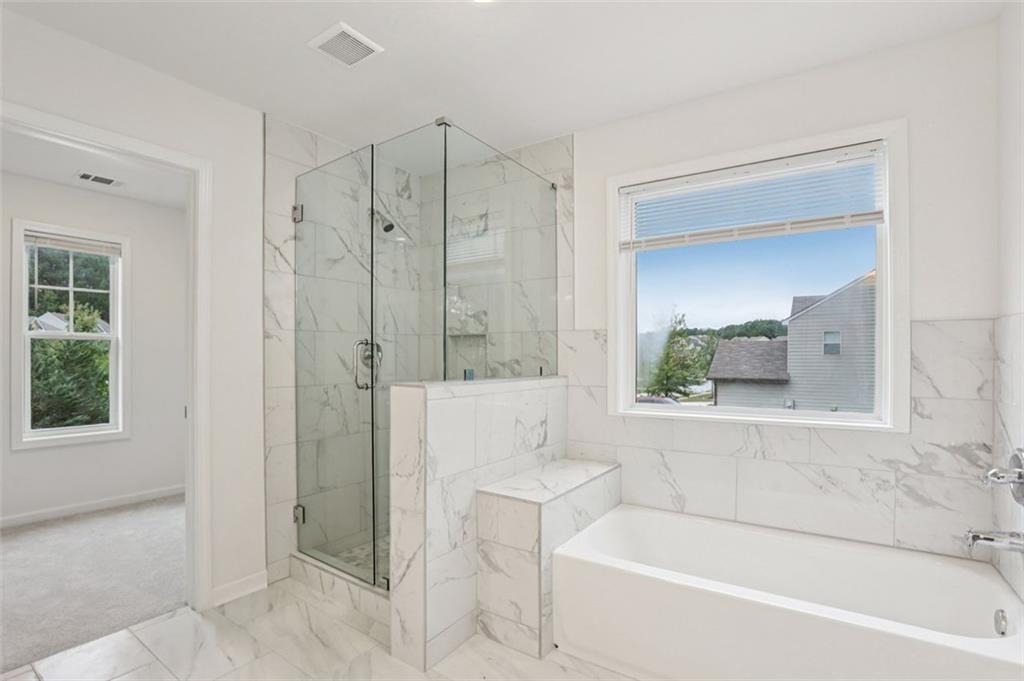 4405 Belcamp Road Fairburn, GA 30213 - Photo 43 of 60 a bathroom with a bathtub shower and toilet