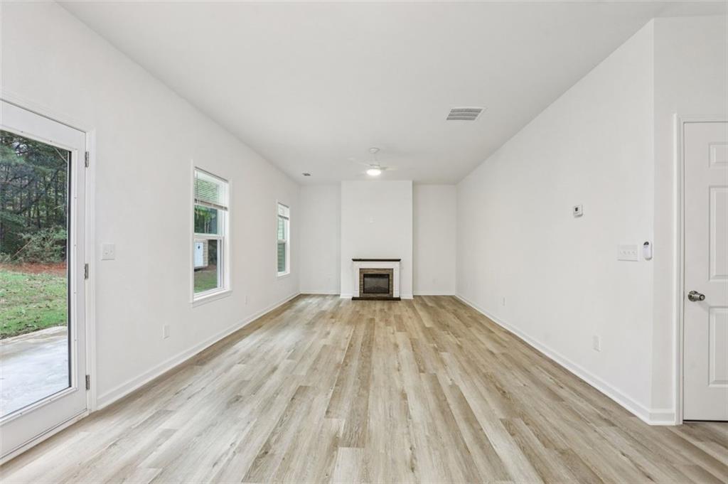 4405 Belcamp Road Fairburn, GA 30213 - Photo 9 of 60 a view of empty room with wooden floor and fan