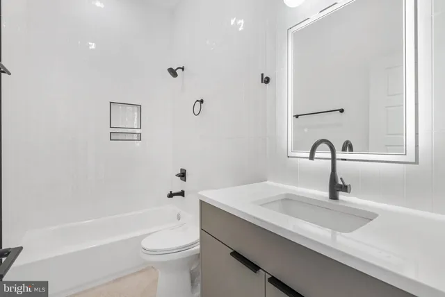 a bathroom with a sink a toilet and a bathtub