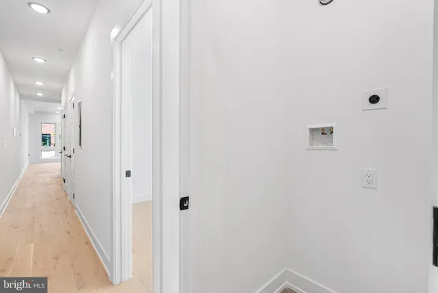 a view of a hallway with wooden floor