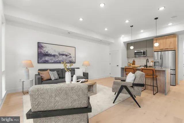 a living room with furniture and kitchen view