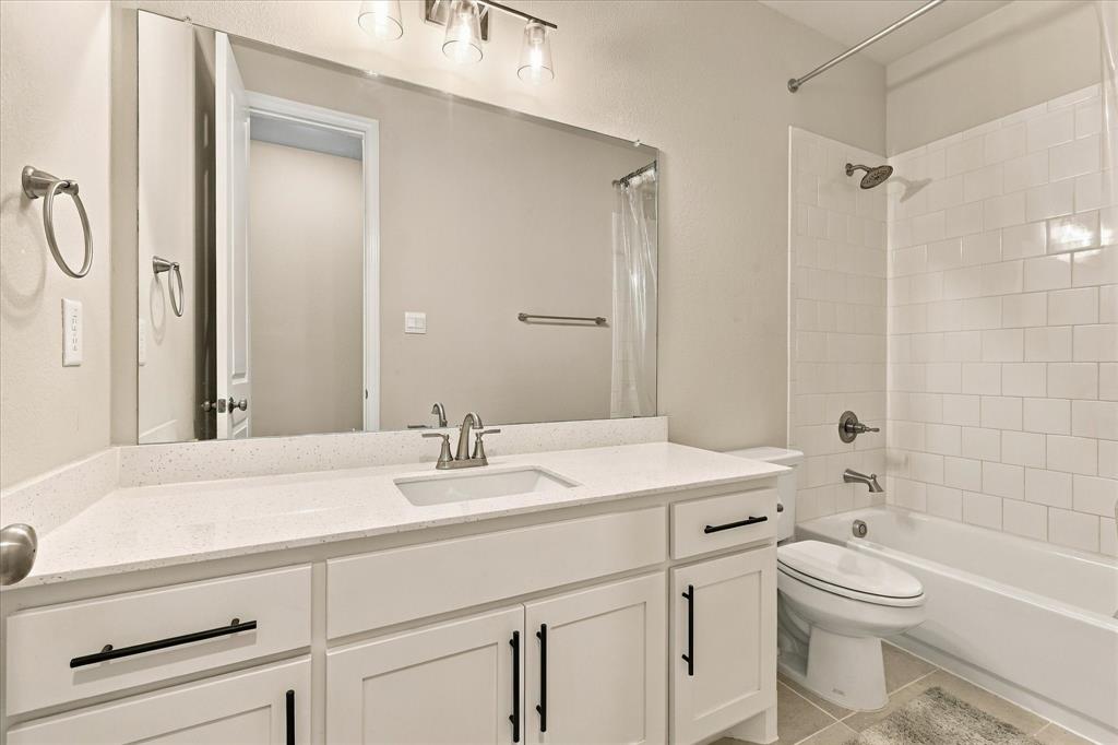 137 Chisos Court Rhome, TX 76078 - Photo 29 of 40 White subway tile surround with a built-in bathtub