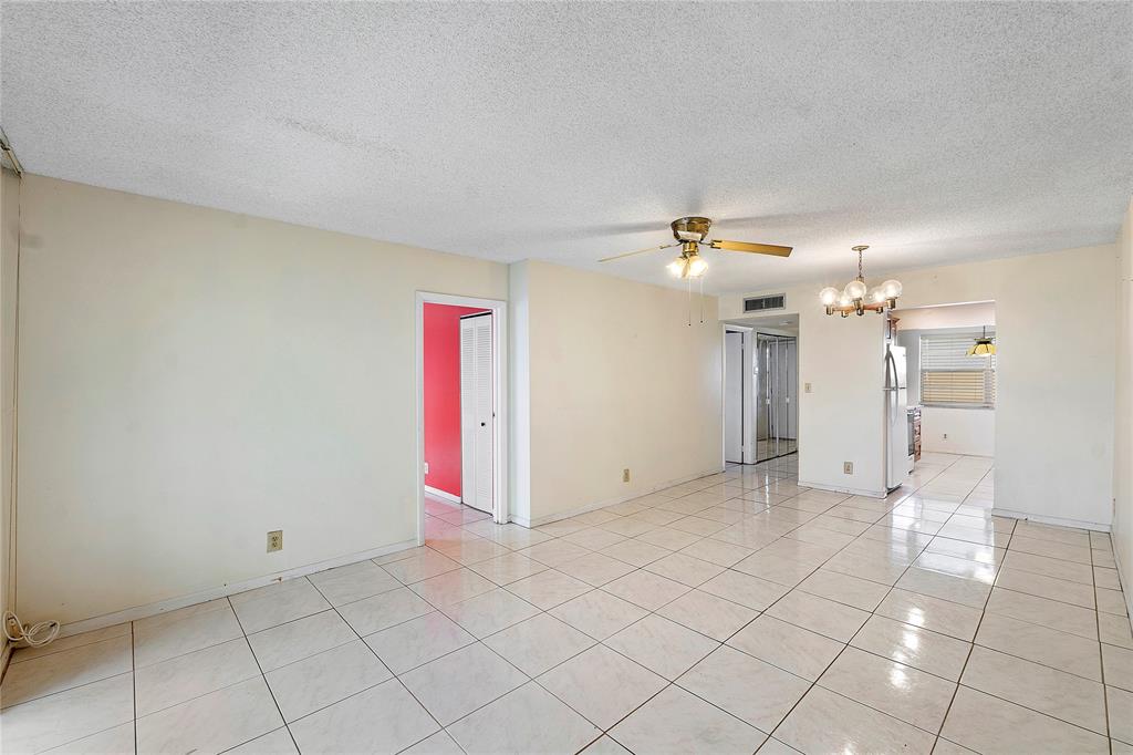 8205 Northwest 61st Street, Unit B305 Tamarac, FL 33321 - Photo 12 of 50 a view of a livingroom with a ceiling fan and window