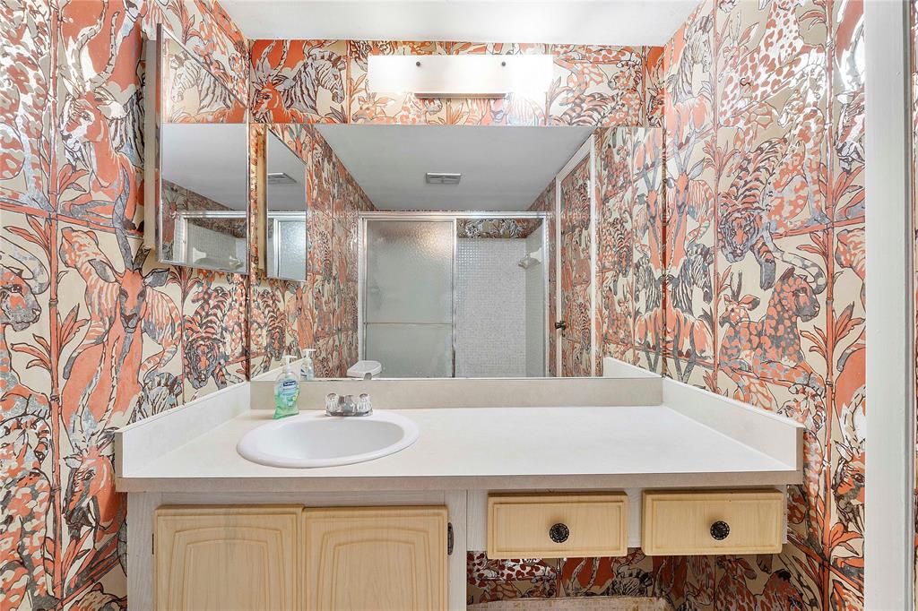 8205 Northwest 61st Street, Unit B305 Tamarac, FL 33321 - Photo 17 of 50 a bathroom with a sink and a mirror