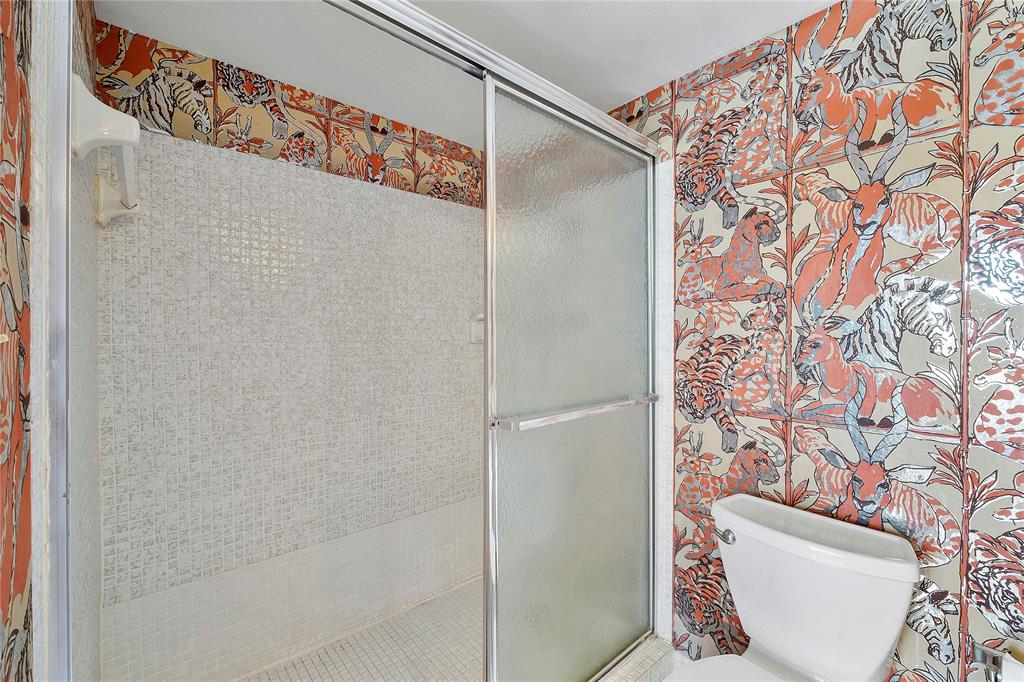 8205 Northwest 61st Street, Unit B305 Tamarac, FL 33321 - Photo 19 of 50 a bathroom with a toilet and shower