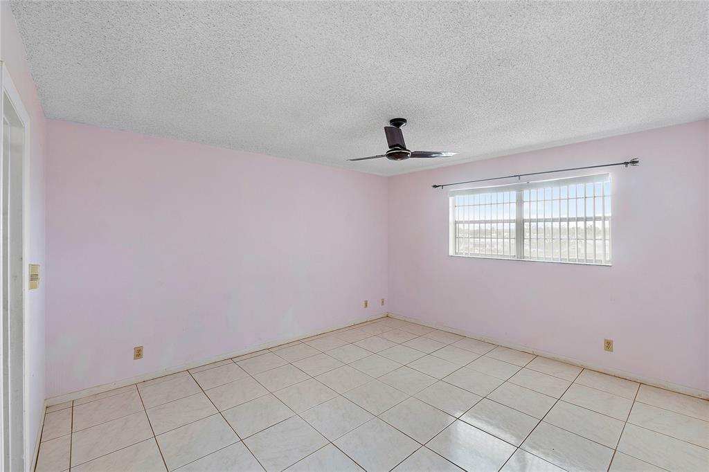 8205 Northwest 61st Street, Unit B305 Tamarac, FL 33321 - Photo 20 of 50 a view of an empty room with a window