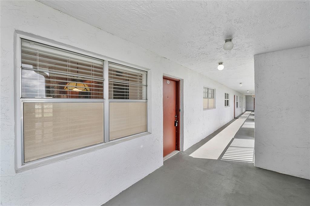 8205 Northwest 61st Street, Unit B305 Tamarac, FL 33321 - Photo 2 of 50 a view of livingroom with hardwood floor and hallway