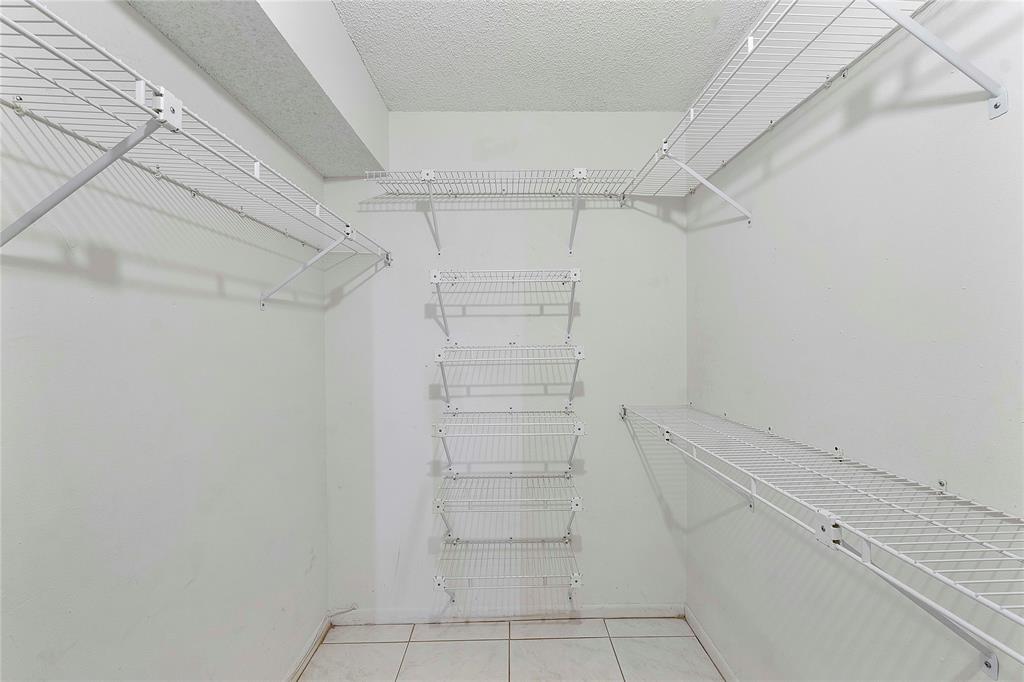8205 Northwest 61st Street, Unit B305 Tamarac, FL 33321 - Photo 27 of 50 a view of walk in closet with empty racks