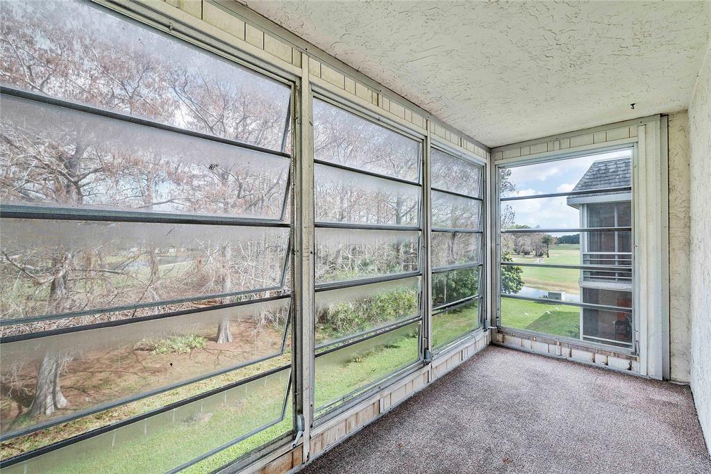 8205 Northwest 61st Street, Unit B305 Tamarac, FL 33321 - Photo 31 of 50 a view of a room with wooden floor and windows