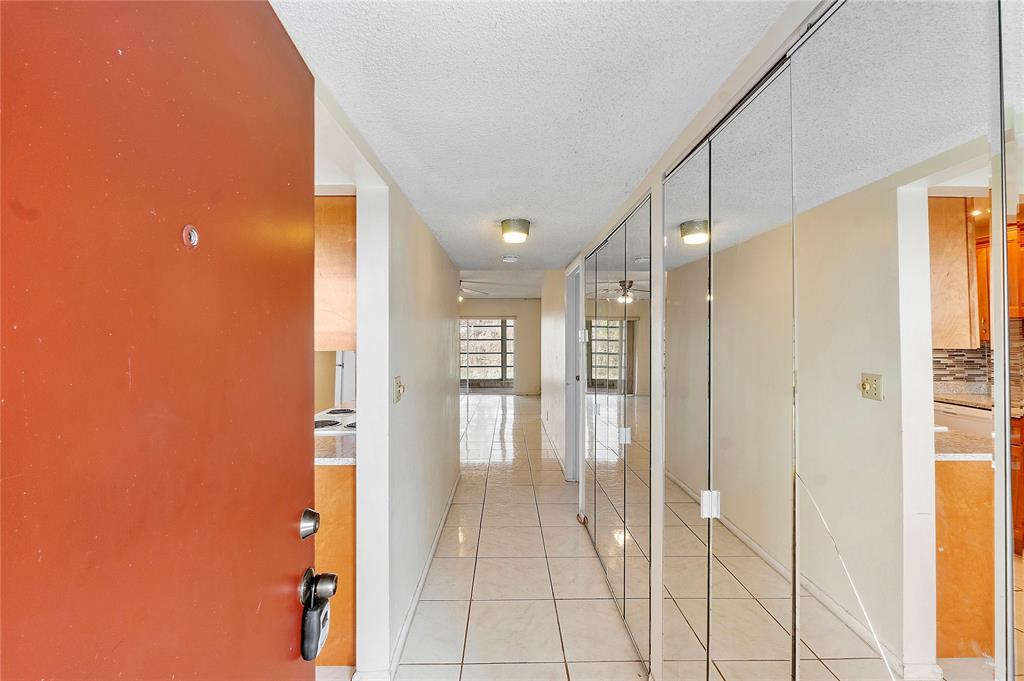 8205 Northwest 61st Street, Unit B305 Tamarac, FL 33321 - Photo 4 of 50 a bathroom with a glass shower door and a bathroom sink