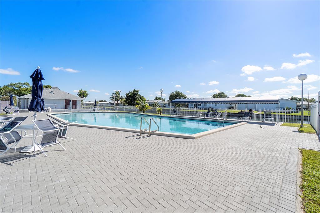 8205 Northwest 61st Street, Unit B305 Tamarac, FL 33321 - Photo 48 of 50 a view of a swimming pool and lounge chair