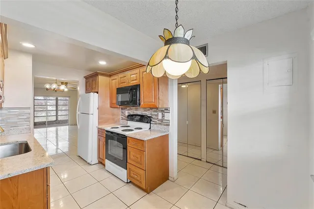 a kitchen with a sink a counter top space cabinets and a window