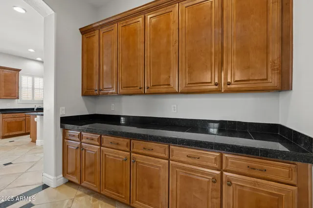 a large kitchen with kitchen island granite countertop a large counter top stainless steel appliances and cabinets