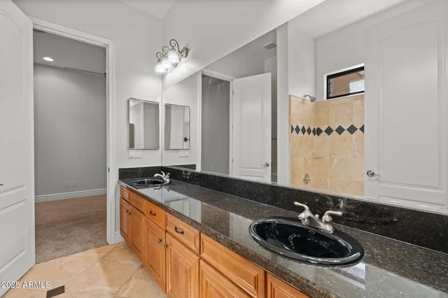 a bathroom with a sink and mirror