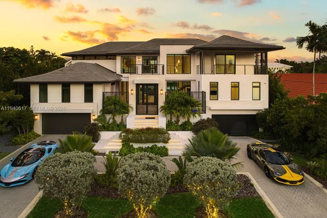 an aerial view of a residential houses with a swimming pool