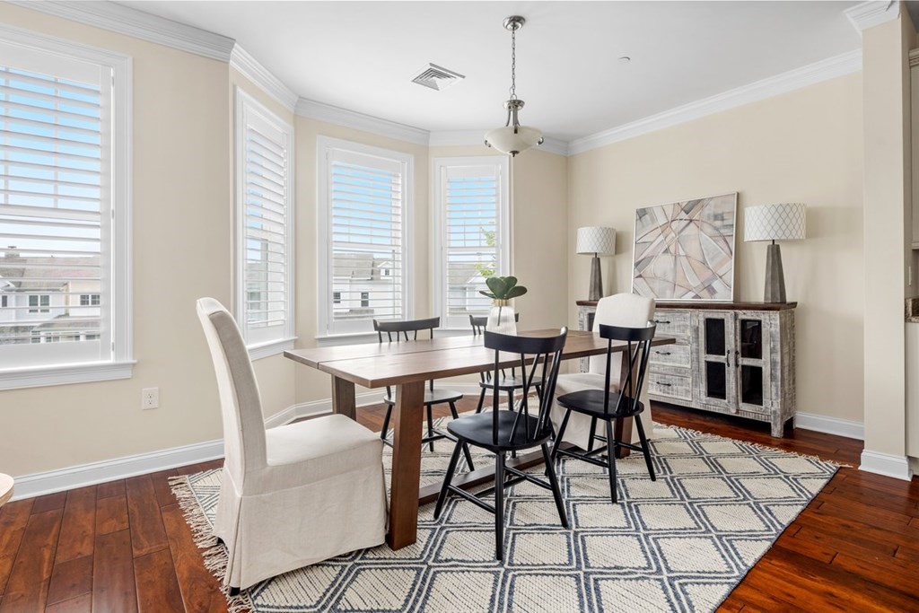 113 Halsted, Unit 113 Hingham, MA 02043 - Photo 13 of 41 a dining room with furniture a rug and wooden floor