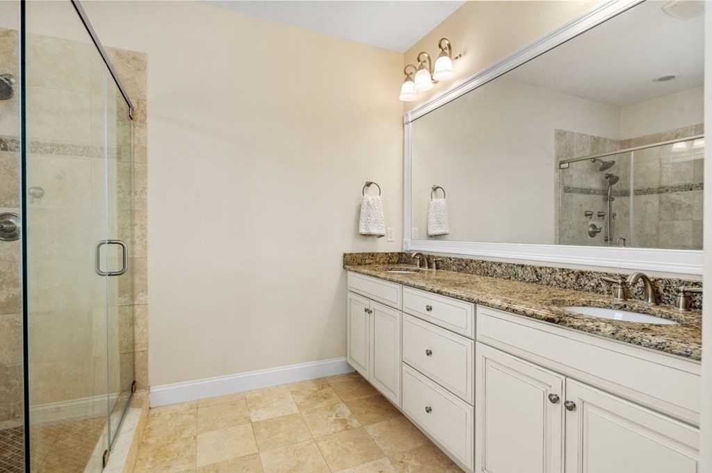 113 Halsted, Unit 113 Hingham, MA 02043 - Photo 19 of 41 a bathroom with a granite countertop sink and a mirror