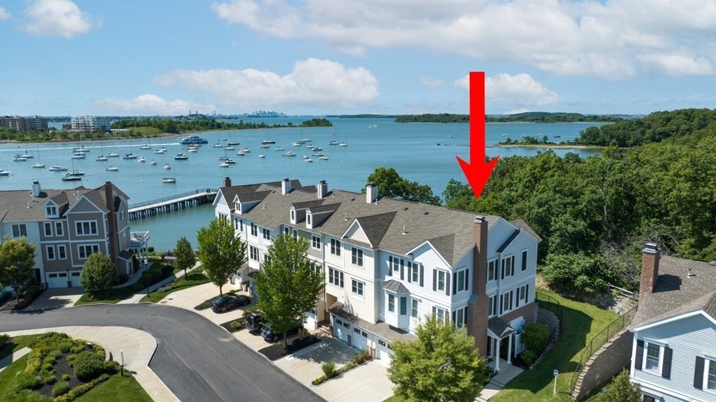 113 Halsted, Unit 113 Hingham, MA 02043 - Photo 2 of 41 a front view of a house with a garden and lake view