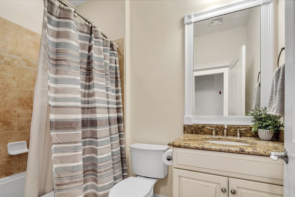 113 Halsted, Unit 113 Hingham, MA 02043 - Photo 22 of 41 a bathroom with a granite countertop sink and a mirror
