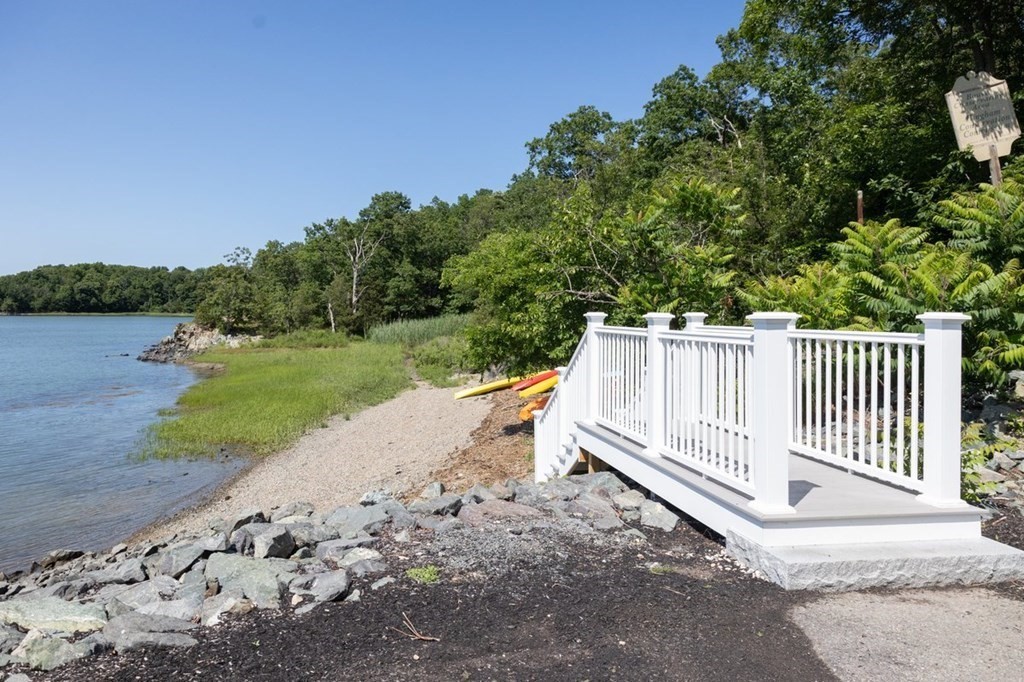 113 Halsted, Unit 113 Hingham, MA 02043 - Photo 26 of 41 a view of a yard with wooden fence and a bench