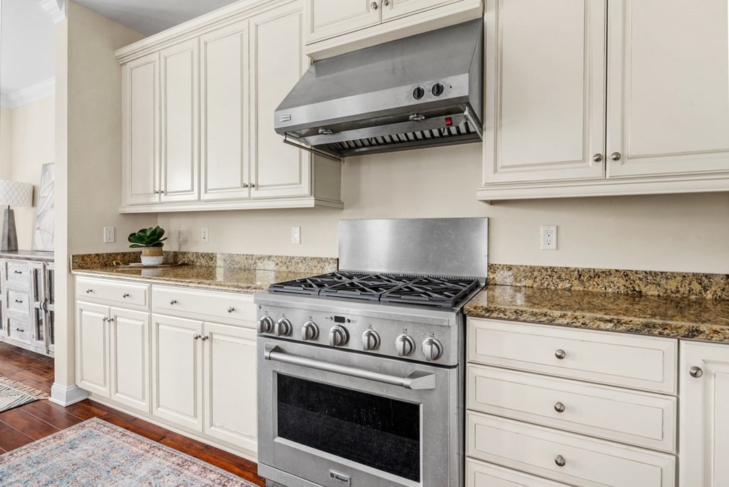 113 Halsted, Unit 113 Hingham, MA 02043 - Photo 10 of 41 a kitchen with granite countertop white cabinets and stainless steel appliances