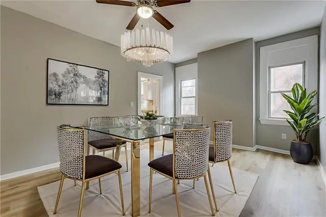 a view of a dining room with furniture and chandelier