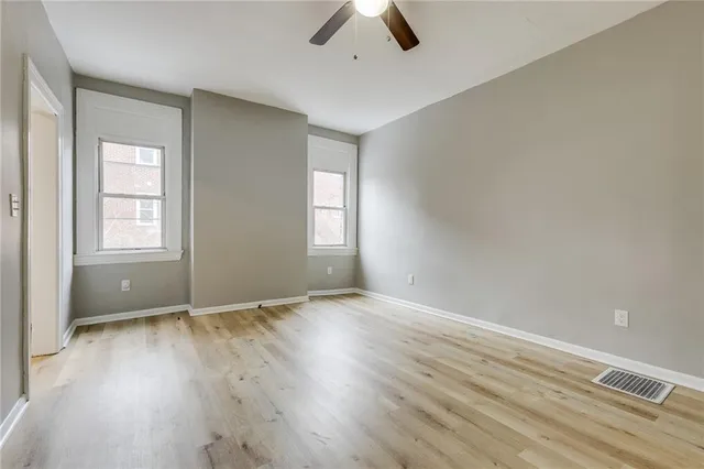 wooden floor in an empty room with a window