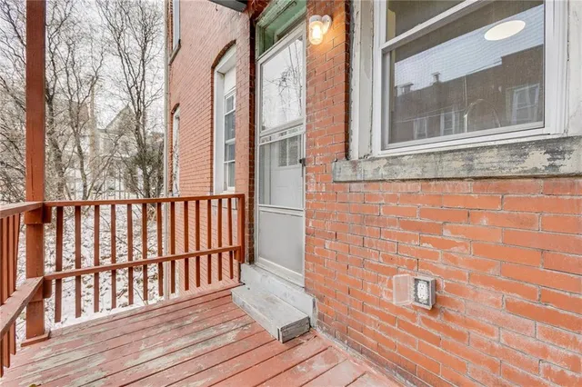 a view of a brick house with wooden floor and floor