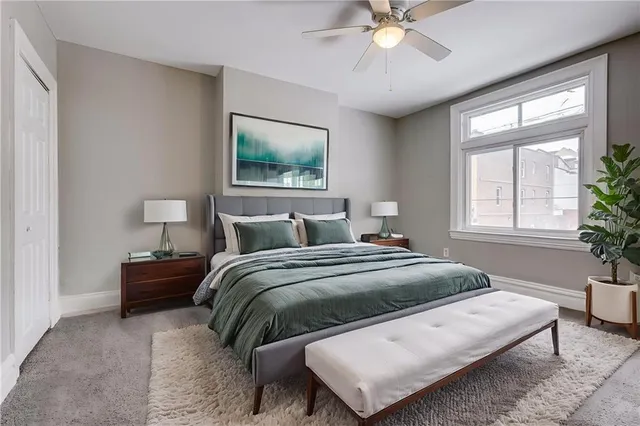 an empty room with closet and a chandelier fan