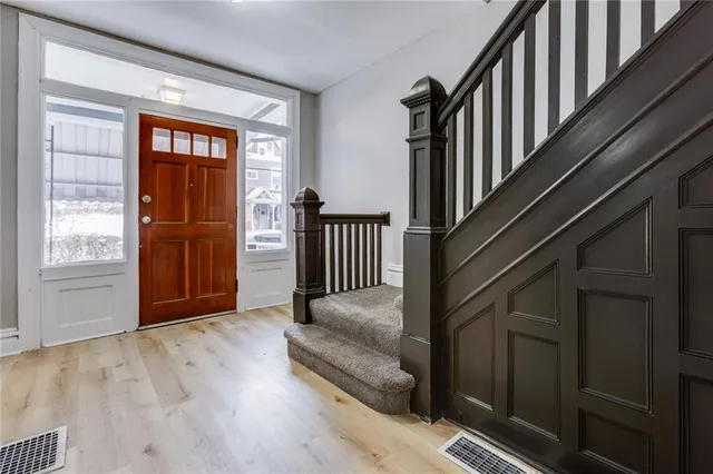 a view of an entryway with wooden floor and door