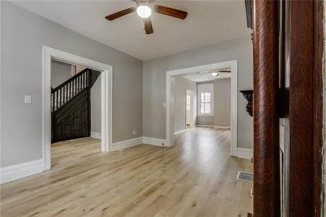 wooden floor in a hall with an entryway and a livingroom