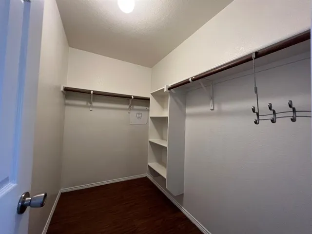 a view of a room with wooden floor