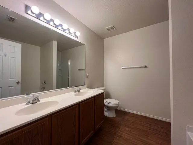 a bathroom with a double vanity sink and a mirror
