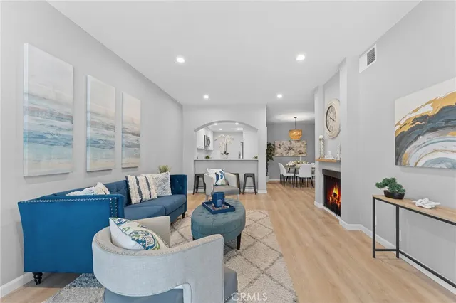 a living room with furniture and a fireplace