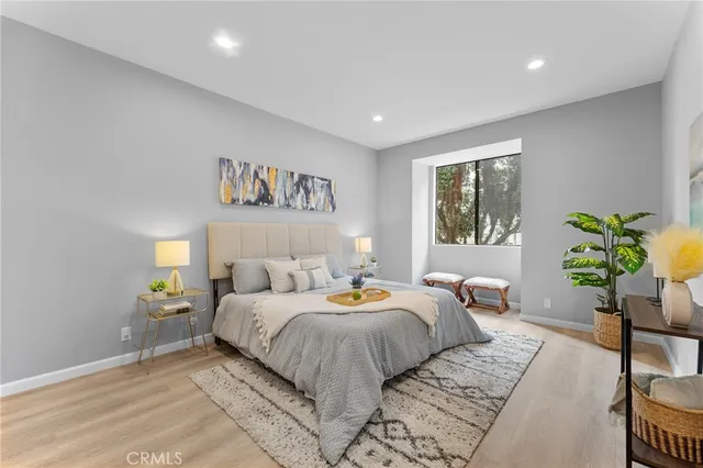 a bedroom with a bed and a potted plant