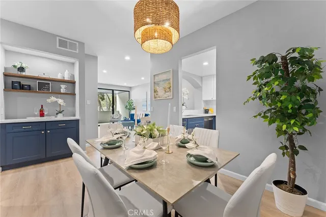 a view of a dining room with furniture and chandelier