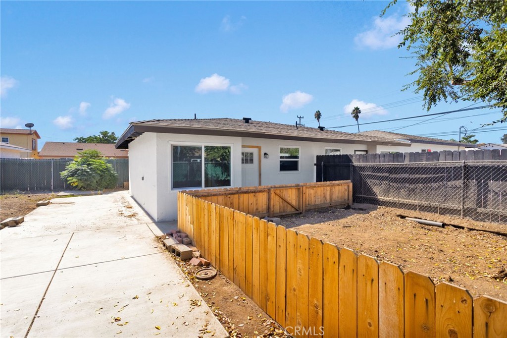 a view of a house with wooden fence